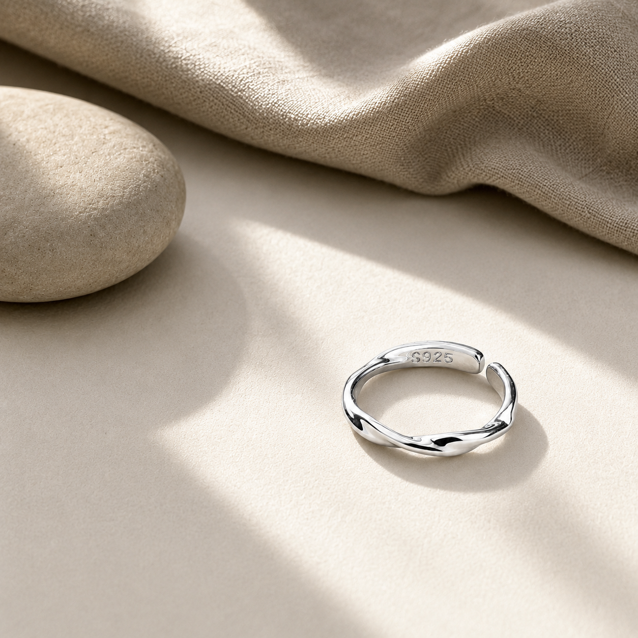 ModClo sterling silver twisted ring styled with linen and stone in a warm, minimal setting