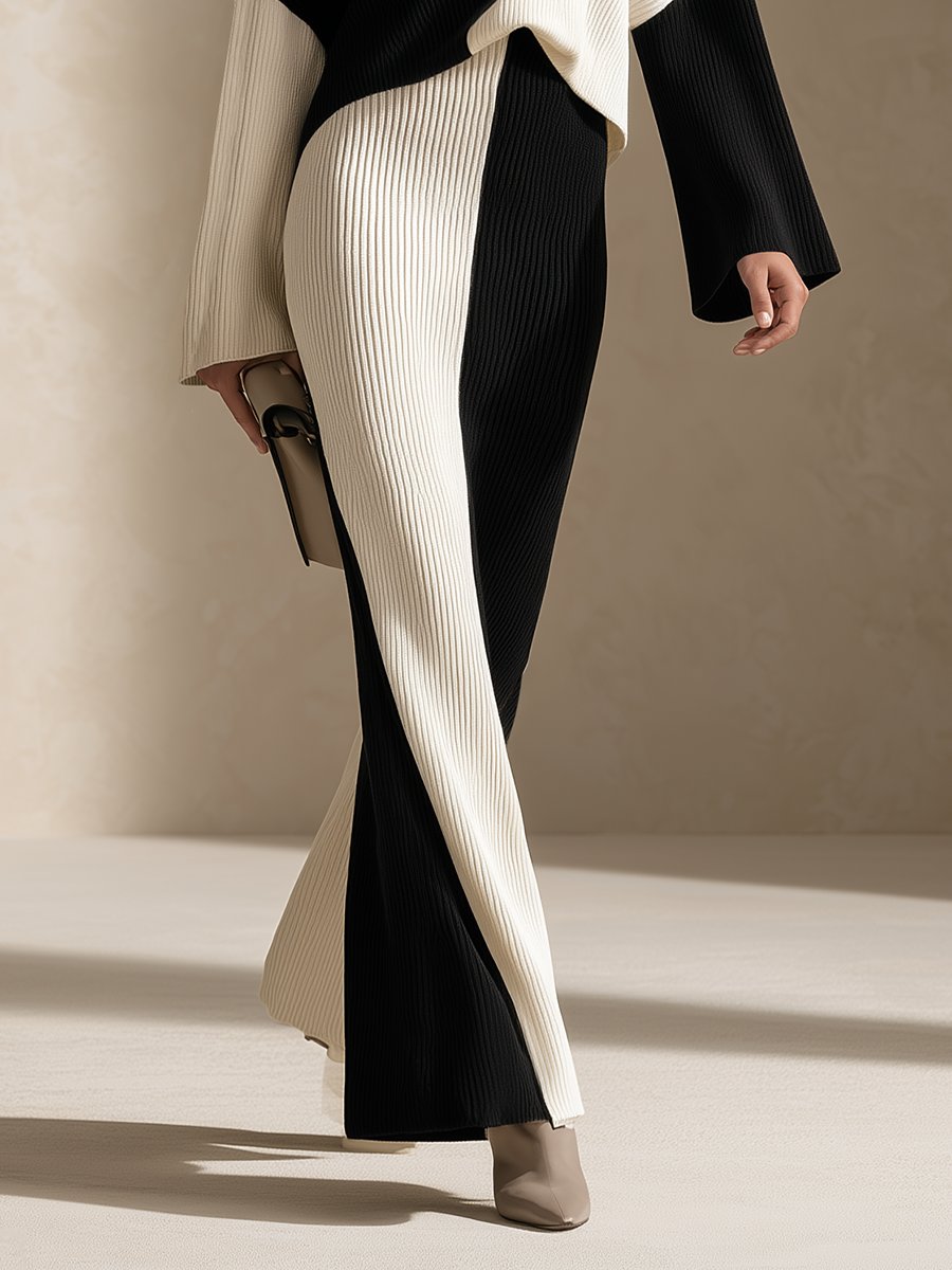 Close-up of a women's black-and-white colorblock ribbed knit maxi set, highlighting the contrasting panels, vertical ribbed texture, slim floor-length skirt, and elegant fitted silhouette.