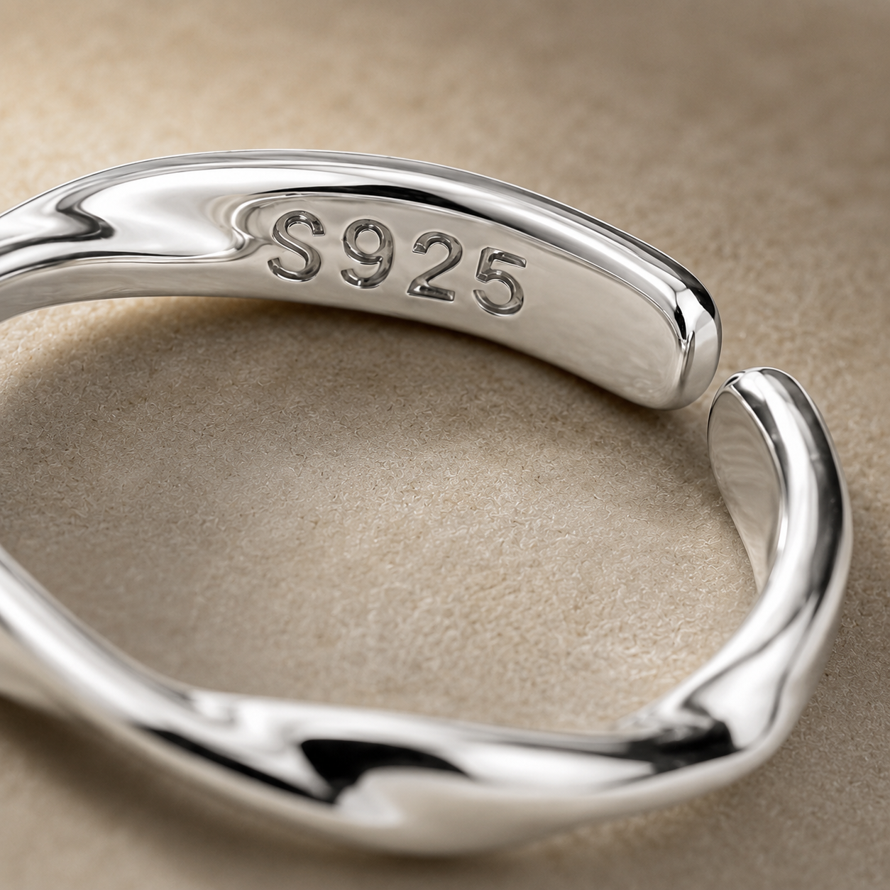 Close-up of the polished twisted band and S925 stamp on the sterling silver adjustable ring