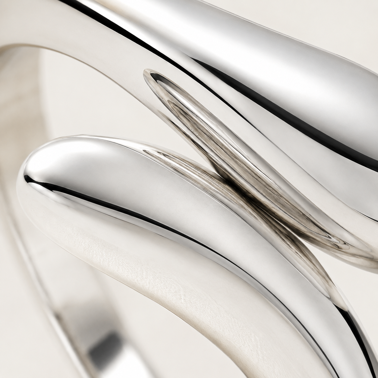 Close-up of the sculptural teardrop ends and high-polish finish on the sterling silver water drop ring