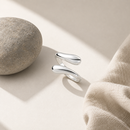 ModClo sterling silver water drop ring styled with linen and stone in a warm, minimal setting